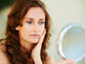 woman looking at herself in the mirror