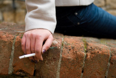 woman holding cigarette woman holding cigarette