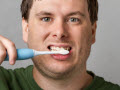 white man brushing his teeth