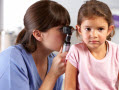 doctor looking into a little girl's ear